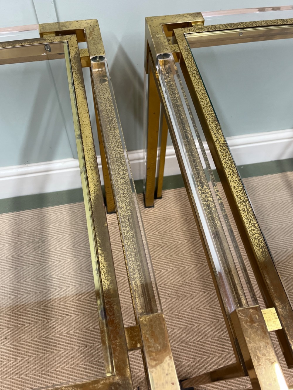 A pair of square side tables featuring brass frames, clear lucite corner inserts, and glass tops. View VIII