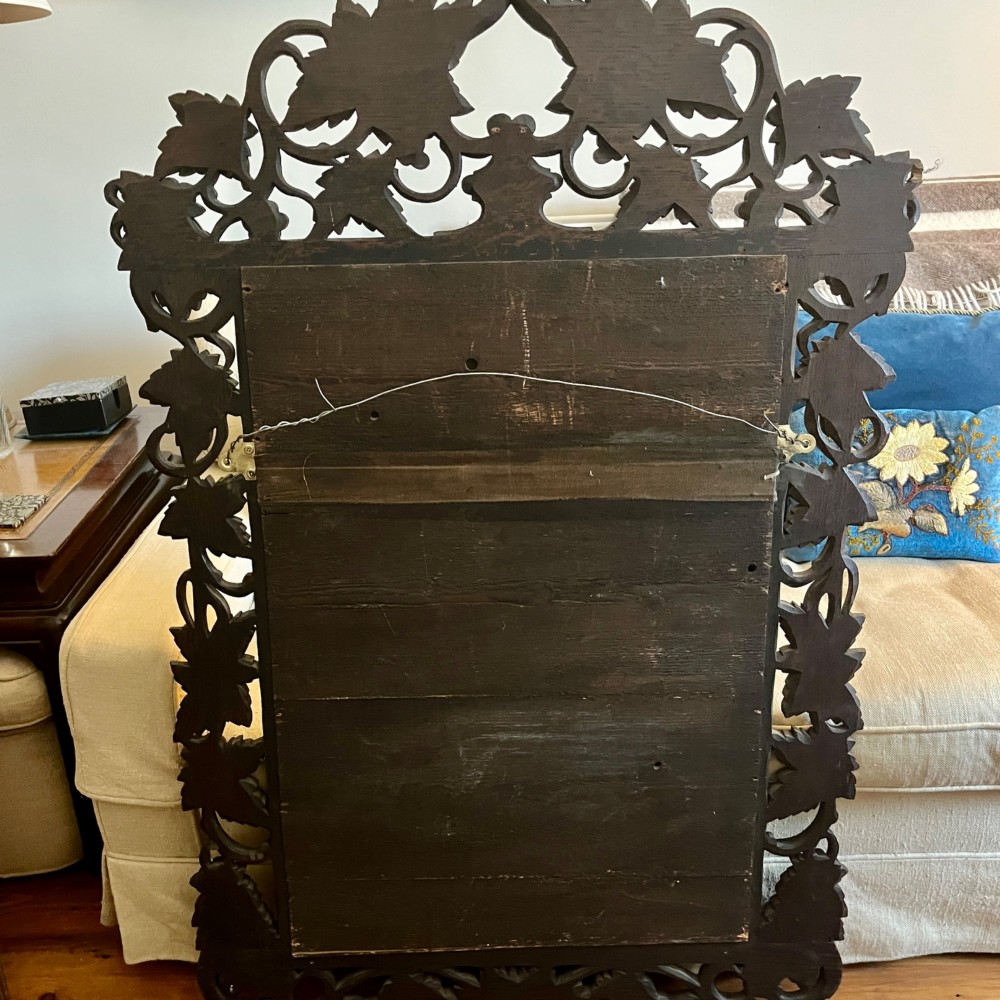 A rectangular nineteenth-century mirror with a heavily hand-carved dark oak frame featuring carved vine leaves, grapes, and foliage. View III