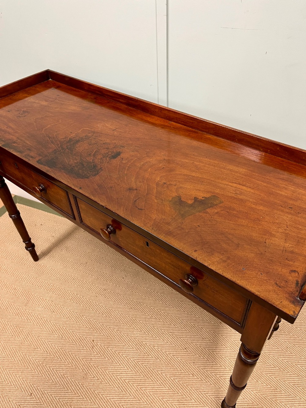A 19th-century mahogany hall table with two frieze drawers, turned legs, and a raised gallery edge along the top. View III