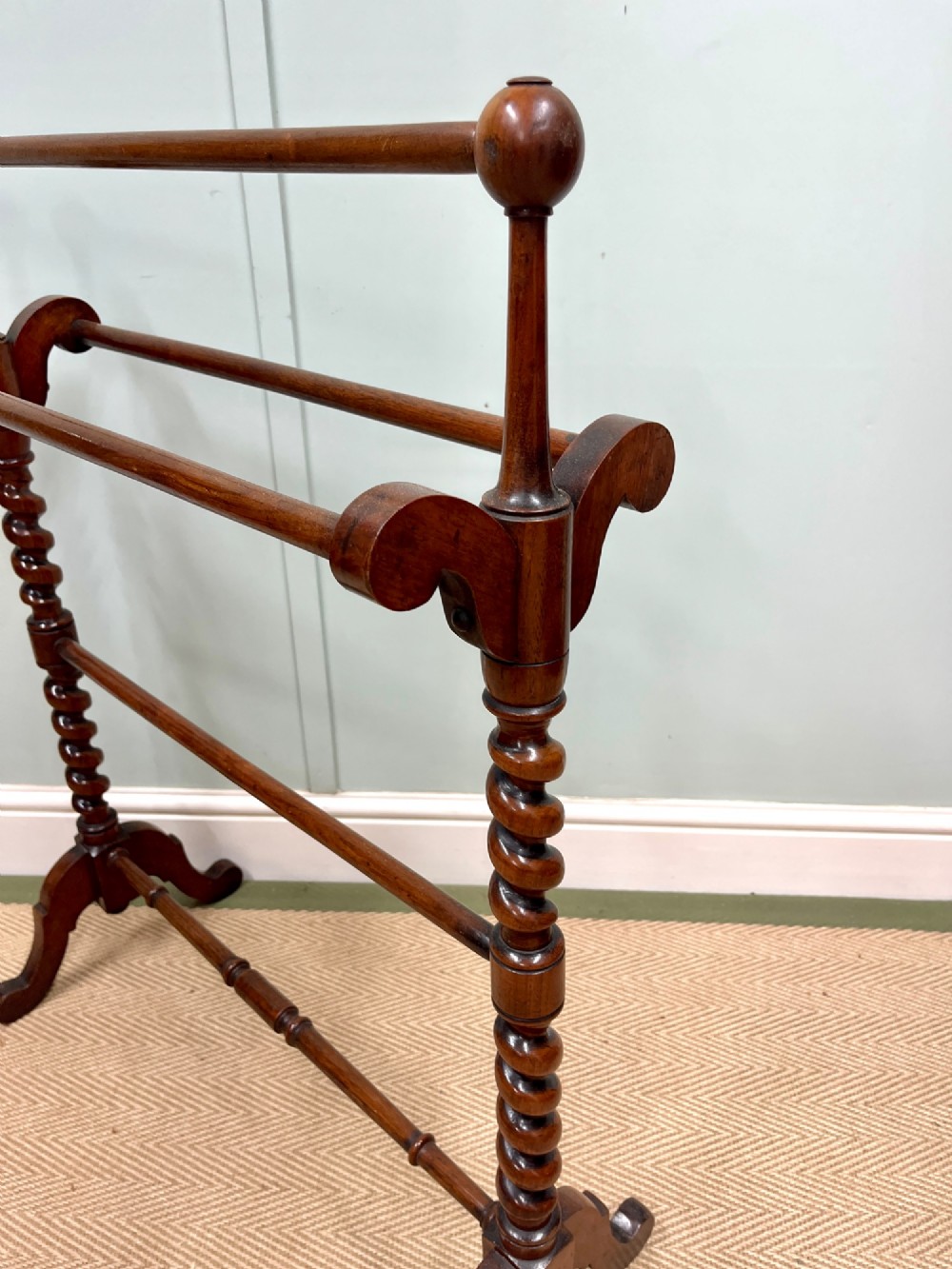 A 19th-century mahogany freestanding towel rail featuring barley twist uprights, turned rails, and carved trestle feet. View II