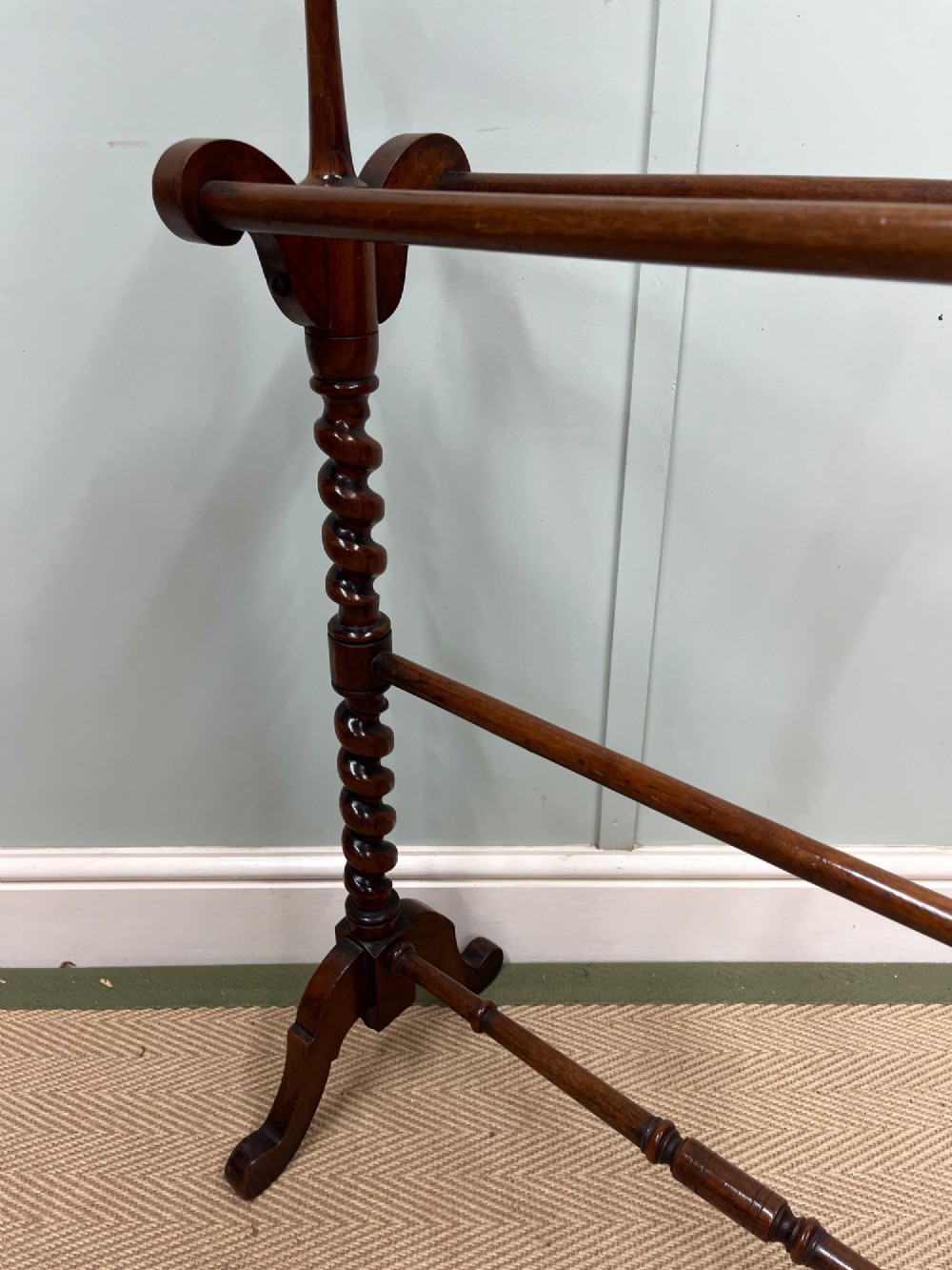 A 19th-century mahogany freestanding towel rail featuring barley twist uprights, turned rails, and carved trestle feet. View III