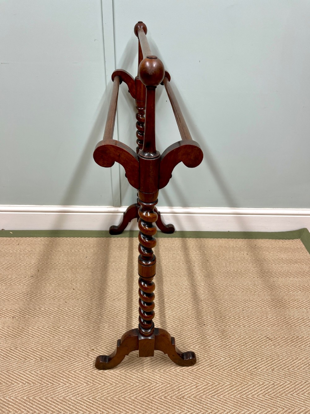 A 19th-century mahogany freestanding towel rail featuring barley twist uprights, turned rails, and carved trestle feet. View V