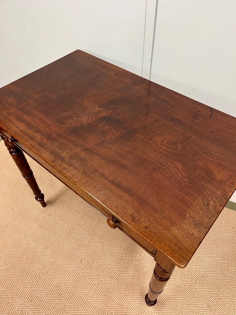 A 19th-century mahogany writing side table featuring a single frieze drawer with two wooden knobs and slender turned legs. View III