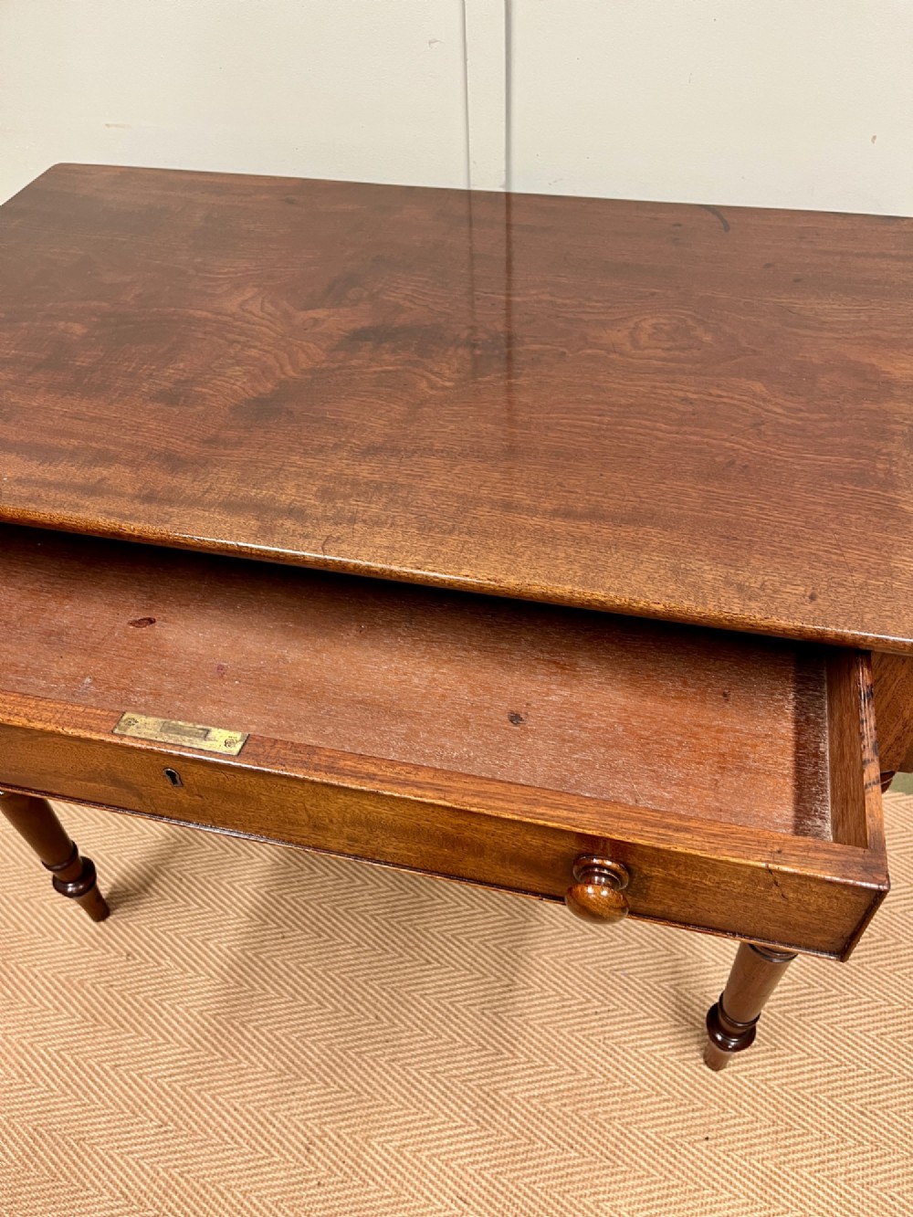A 19th-century mahogany writing side table featuring a single frieze drawer with two wooden knobs and slender turned legs. View V