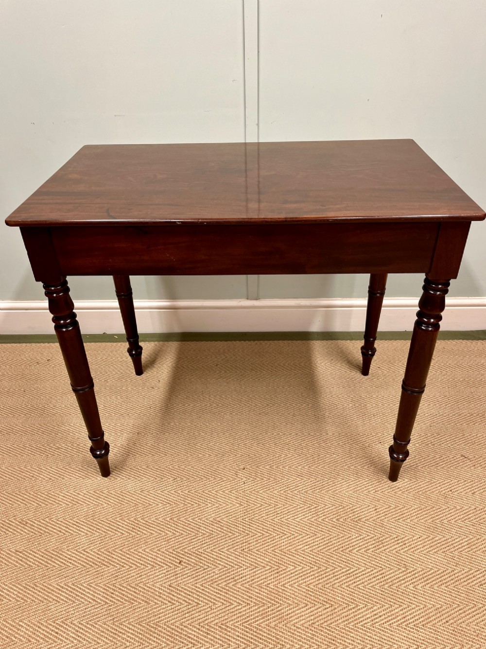 A 19th-century mahogany writing side table featuring a single frieze drawer with two wooden knobs and slender turned legs. View VII