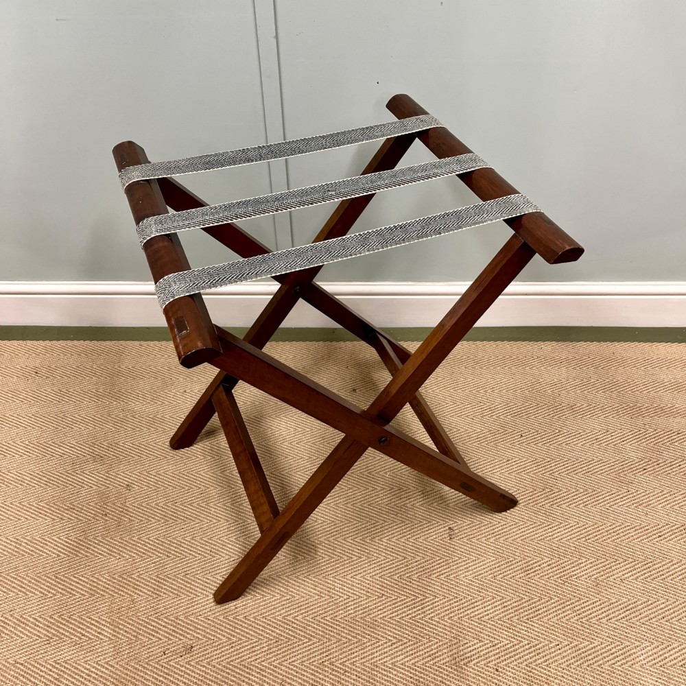 A 19th-century mahogany butlers tray featuring hinged drop sides and hand-cut handles set on a matching folding X-frame stand. View IV