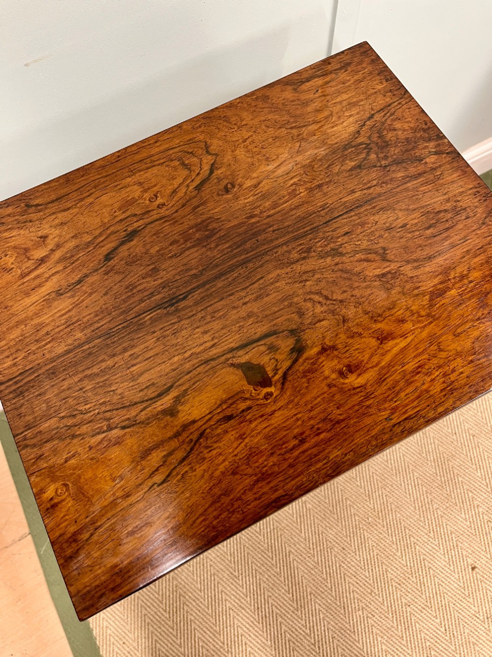 A 19th-century rosewood games table with a polished rectangular fold-over top, a faceted pedestal column, and a quadform base on flattened bun feet. View IV