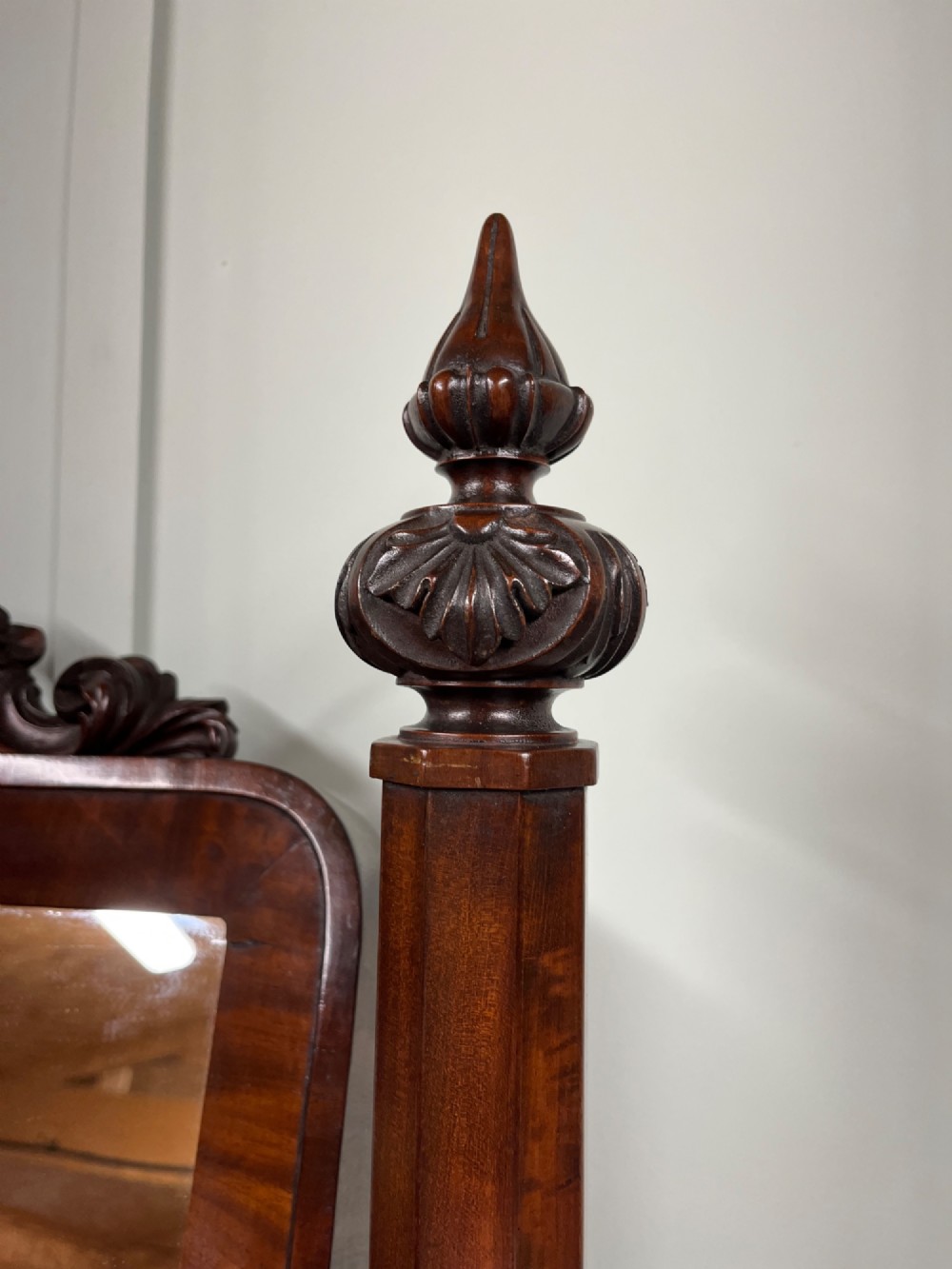 A 19th-century mahogany swing toilet mirror featuring carved support columns, two attached brass candle sconces, and a serpentine plinth base. View VI