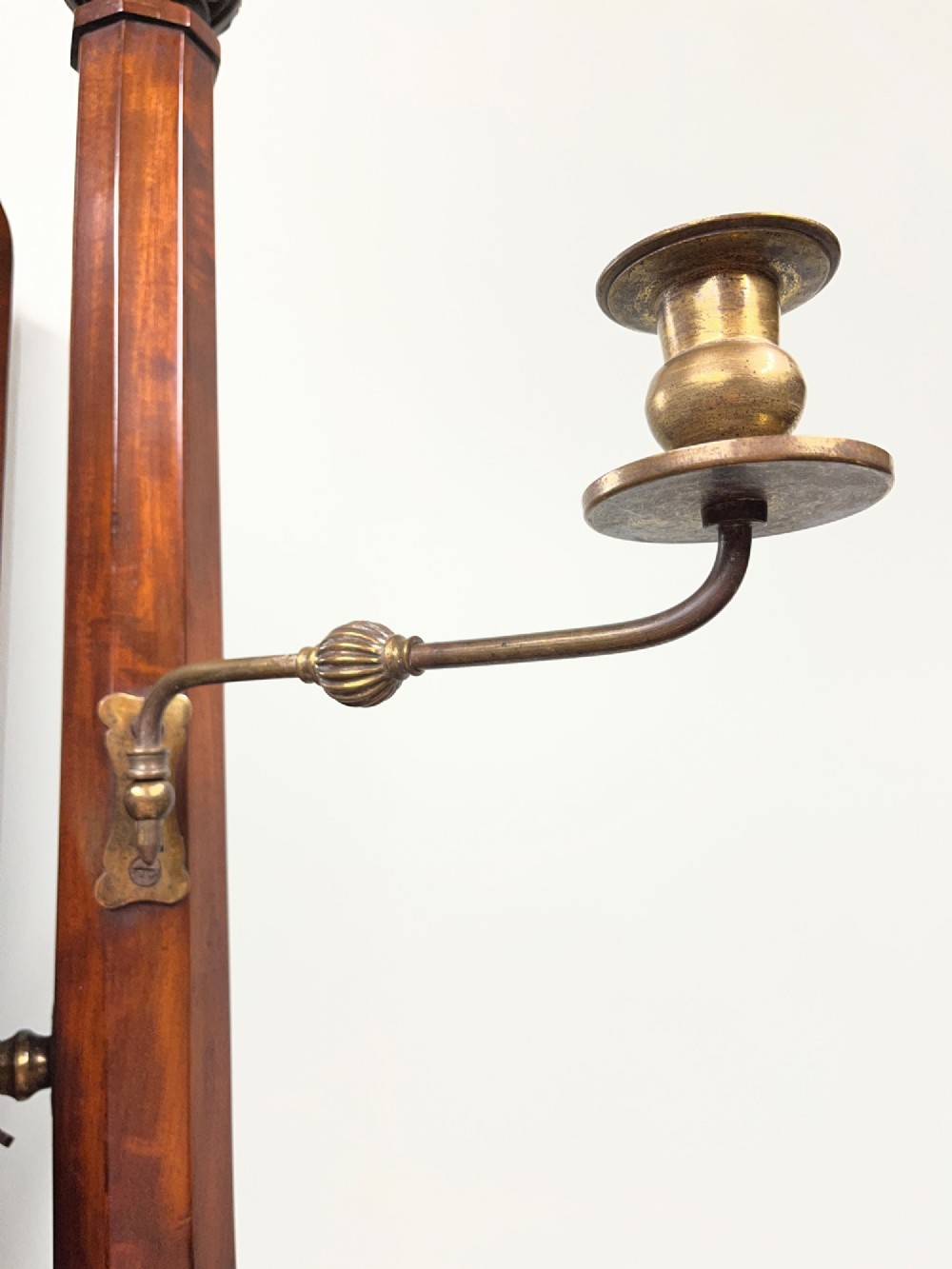 A 19th-century mahogany swing toilet mirror featuring carved support columns, two attached brass candle sconces, and a serpentine plinth base. View VII