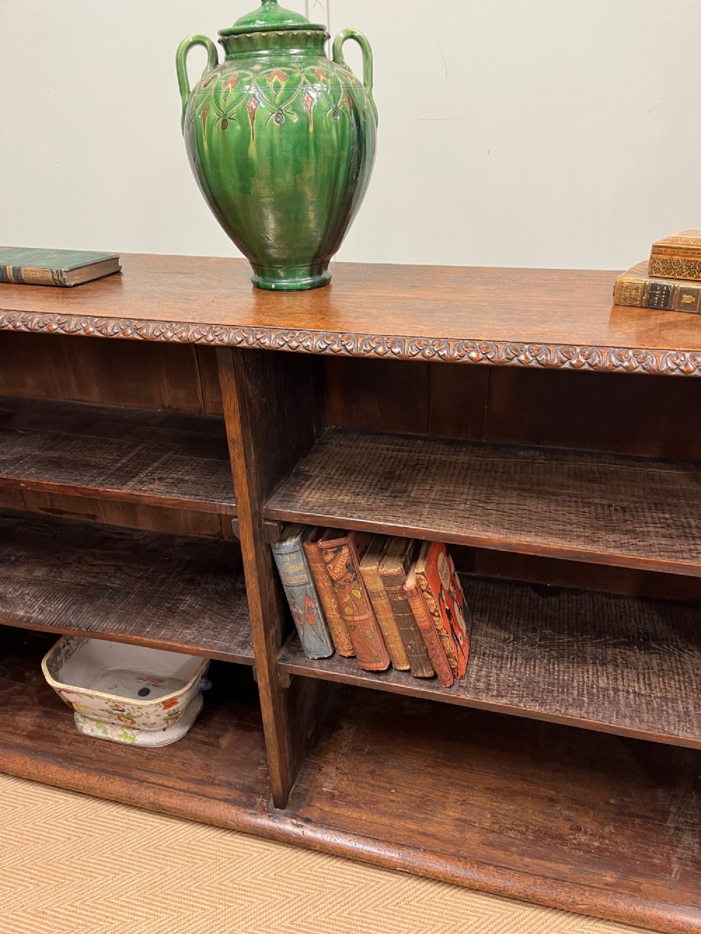 A low nineteenth-century open teak bookcase featuring two main sections with adjustable shelves and a carved egg-and-dart moulding along the top rim. View III