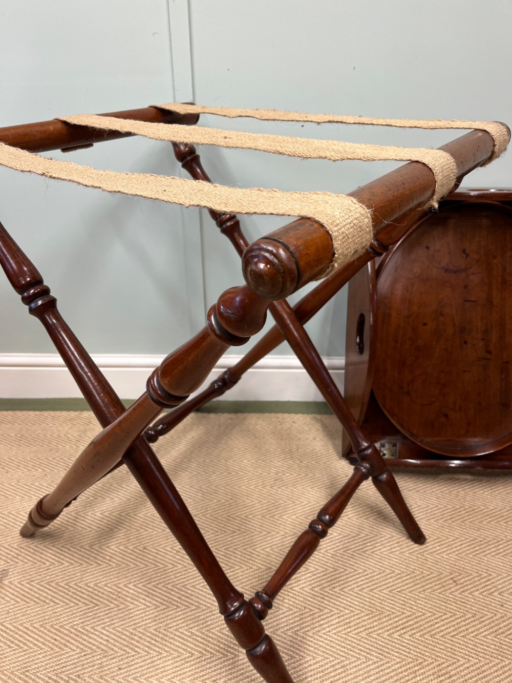 A 19th-century mahogany butlers tray with drop-down hinged sides and cutout hand-holes, set upon a turned folding X-frame stand. View VIII