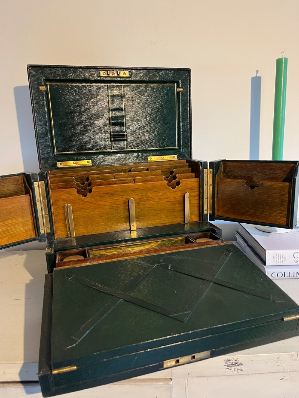 An open nineteenth-century dark green leather stationery box featuring brass fittings, interior memo panels, and compartmentalised sections. View II