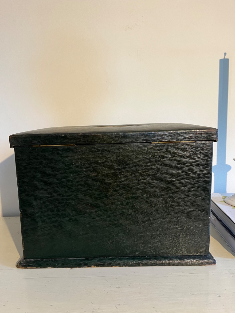 An open nineteenth-century dark green leather stationery box featuring brass fittings, interior memo panels, and compartmentalised sections. View XII