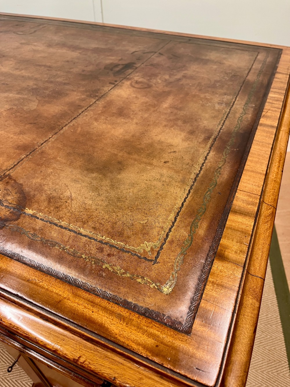 A nineteenth-century mahogany partners desk featuring an inset brown leather top, multiple drawers with turned wooden knobs, and twin pedestal bases. View III