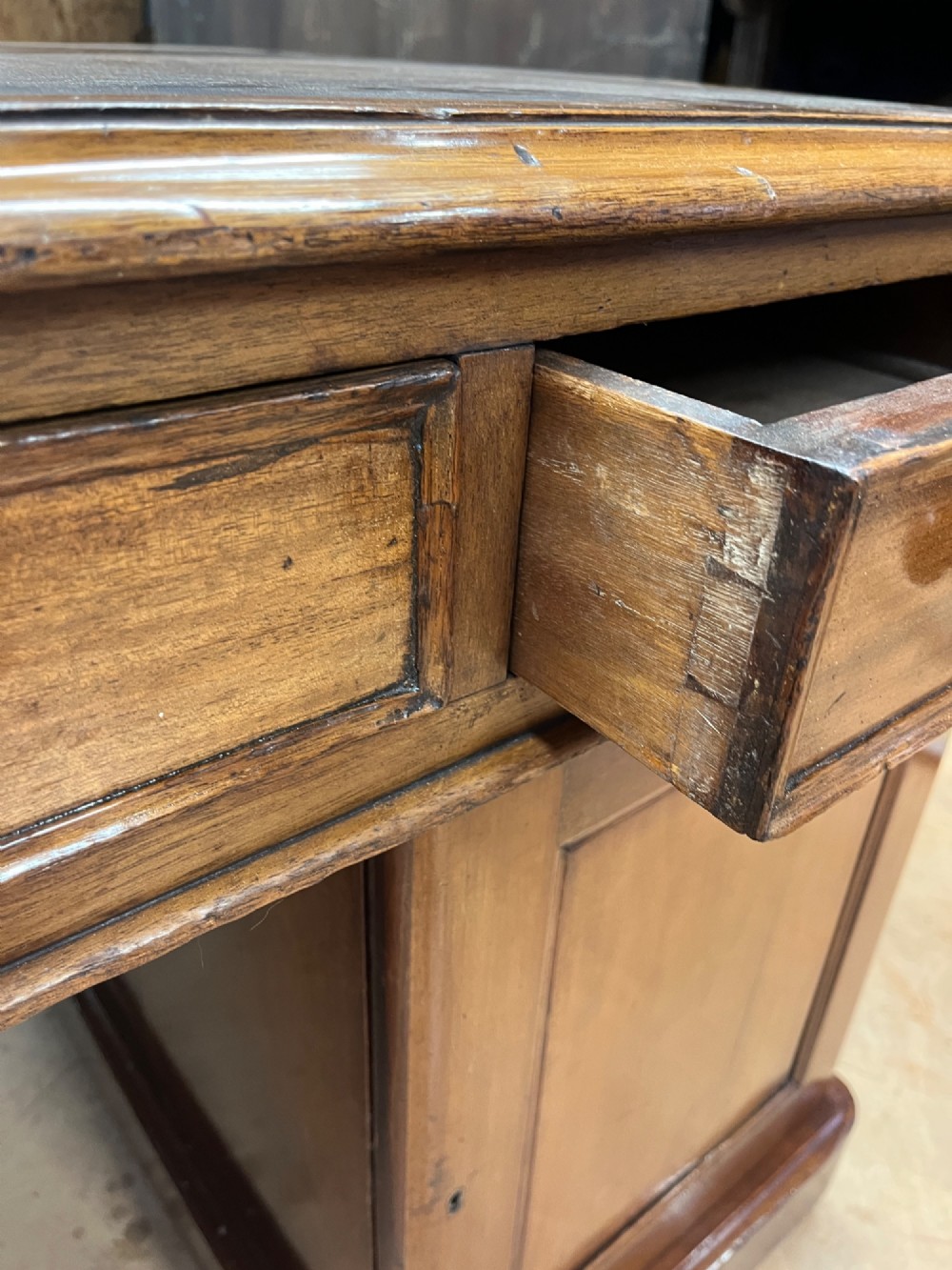 A nineteenth-century mahogany partners desk featuring an inset brown leather top, multiple drawers with turned wooden knobs, and twin pedestal bases. View VIII