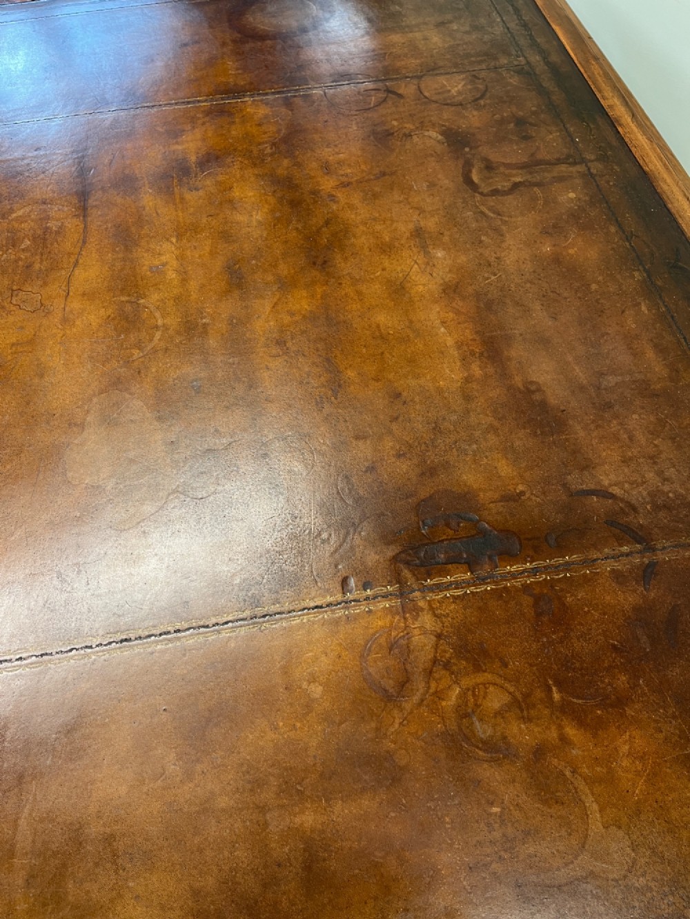 A nineteenth-century mahogany partners desk featuring an inset brown leather top, multiple drawers with turned wooden knobs, and twin pedestal bases. View XI