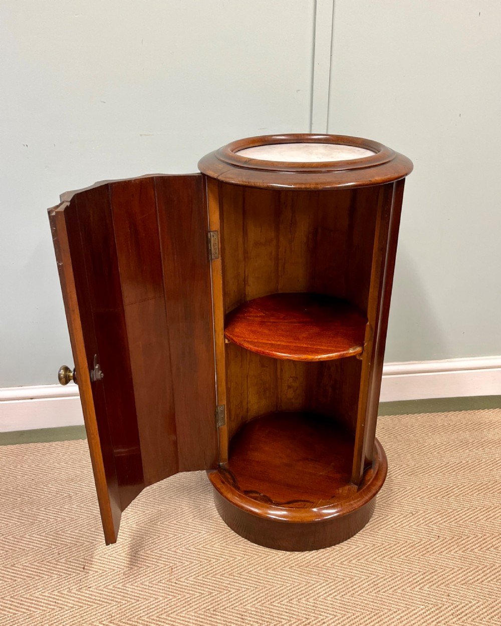 A 19th-century cylindrical dark mahogany pot cupboard featuring vertical fluting, a circular inset marble top, a single curved door, and a brass knob. View III