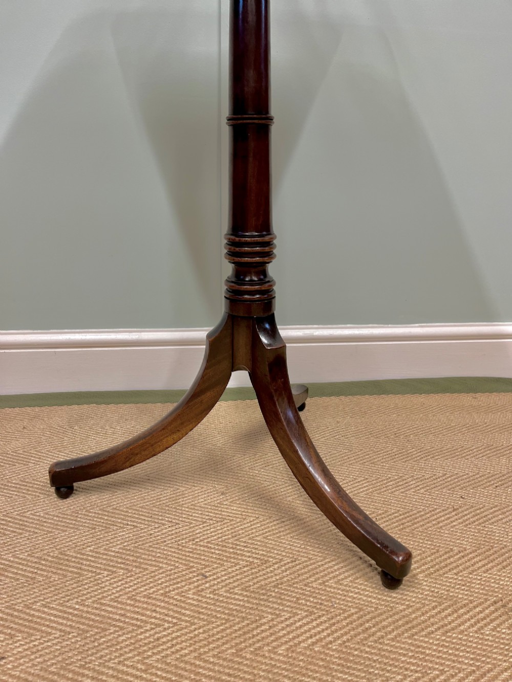 A 19th-century mahogany snap-top side table featuring a square top with rounded corners, a turned central column, and three splayed legs. View IV