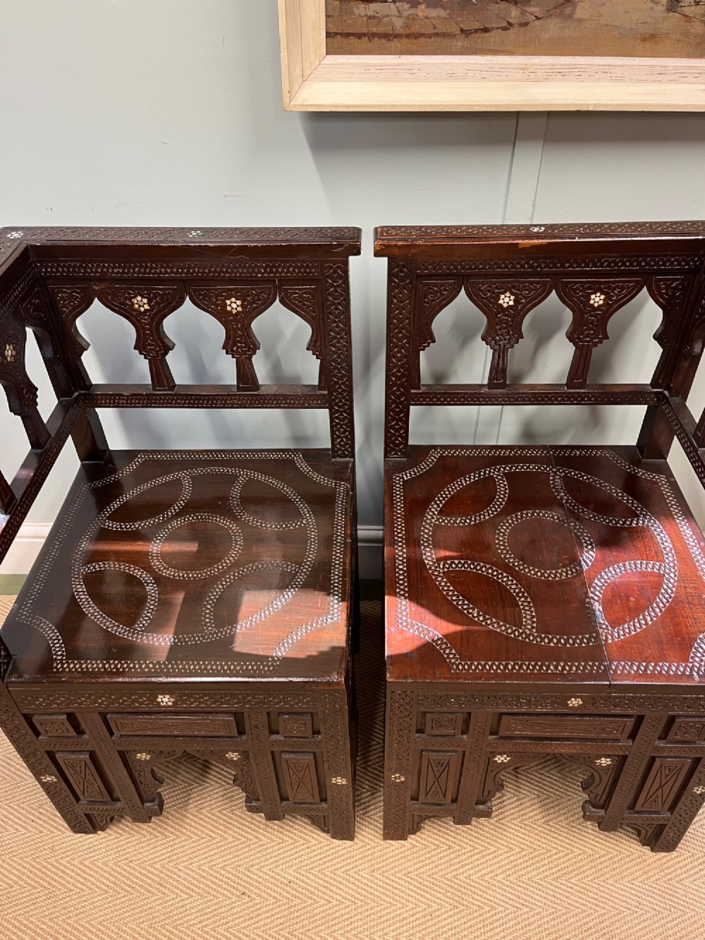 A pair of dark wood early 20th-century Moorish corner tables featuring geometric bone inlay and carved mashrabiya arch galleries. View II
