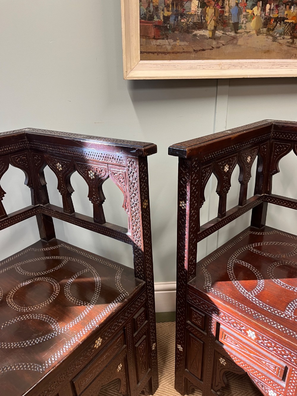 A pair of dark wood early 20th-century Moorish corner tables featuring geometric bone inlay and carved mashrabiya arch galleries. View V