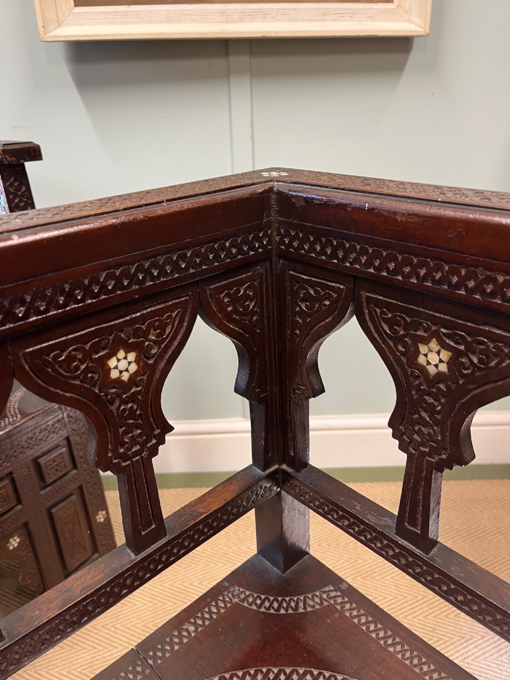 A pair of dark wood early 20th-century Moorish corner tables featuring geometric bone inlay and carved mashrabiya arch galleries. View VI