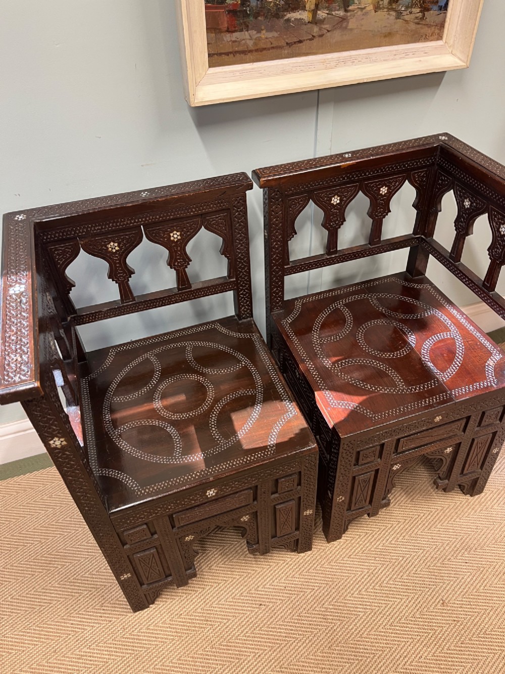 A pair of dark wood early 20th-century Moorish corner tables featuring geometric bone inlay and carved mashrabiya arch galleries. View VII