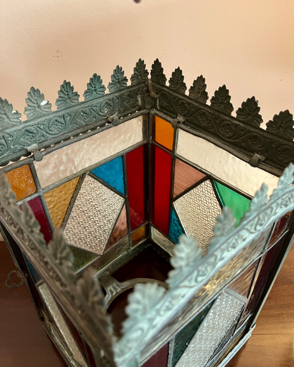 A nineteenth-century four-sided brass hall lantern featuring multi-coloured stained glass panels and a decorative cresting rim suspended from an arched handle. View III