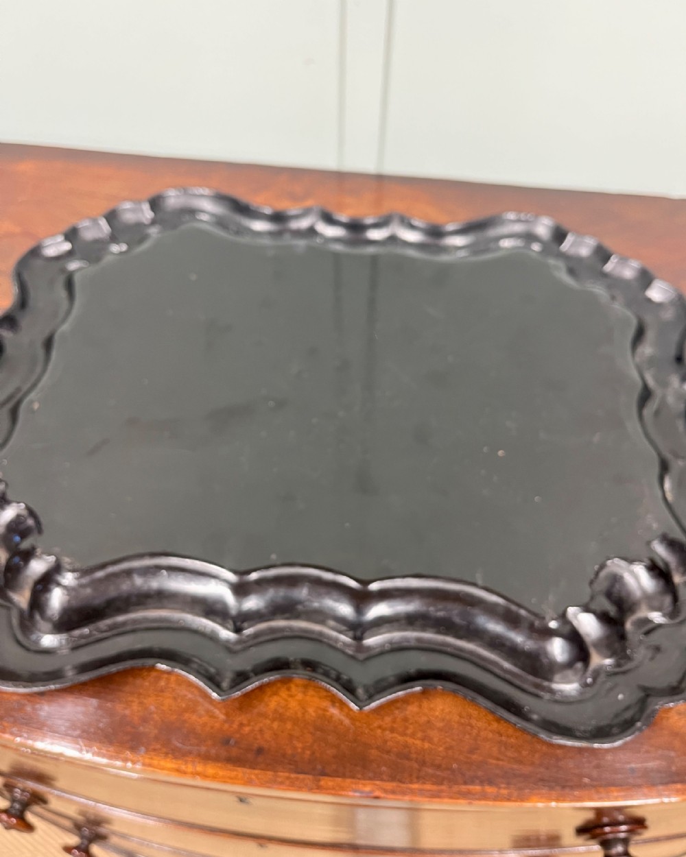 A black scalloped Regency papier-mache tray featuring a hand-painted mountain landscape encircled by a gilded decorative border. View IV