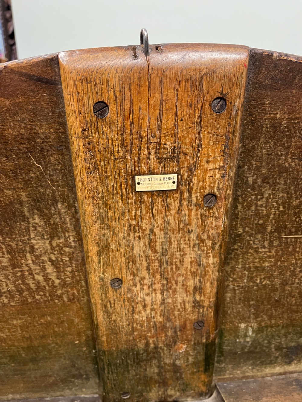 A circular 19th-century mahogany coaching table featuring a central hinged seam and brass hardware on turned legs. View VII