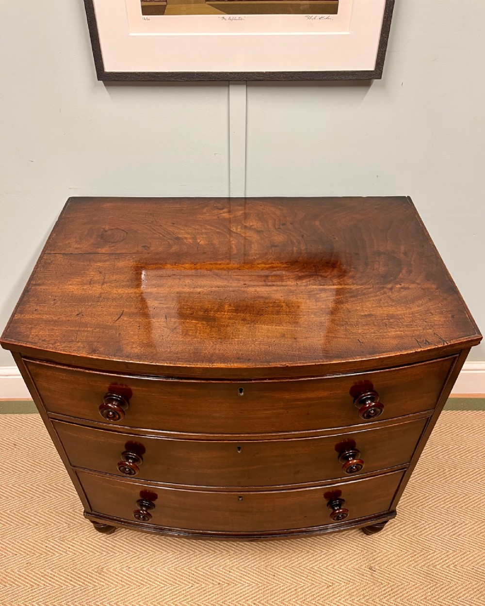A 19th-century mahogany bowfront chest of drawers featuring three graduated drawers with turned wooden handles. View II