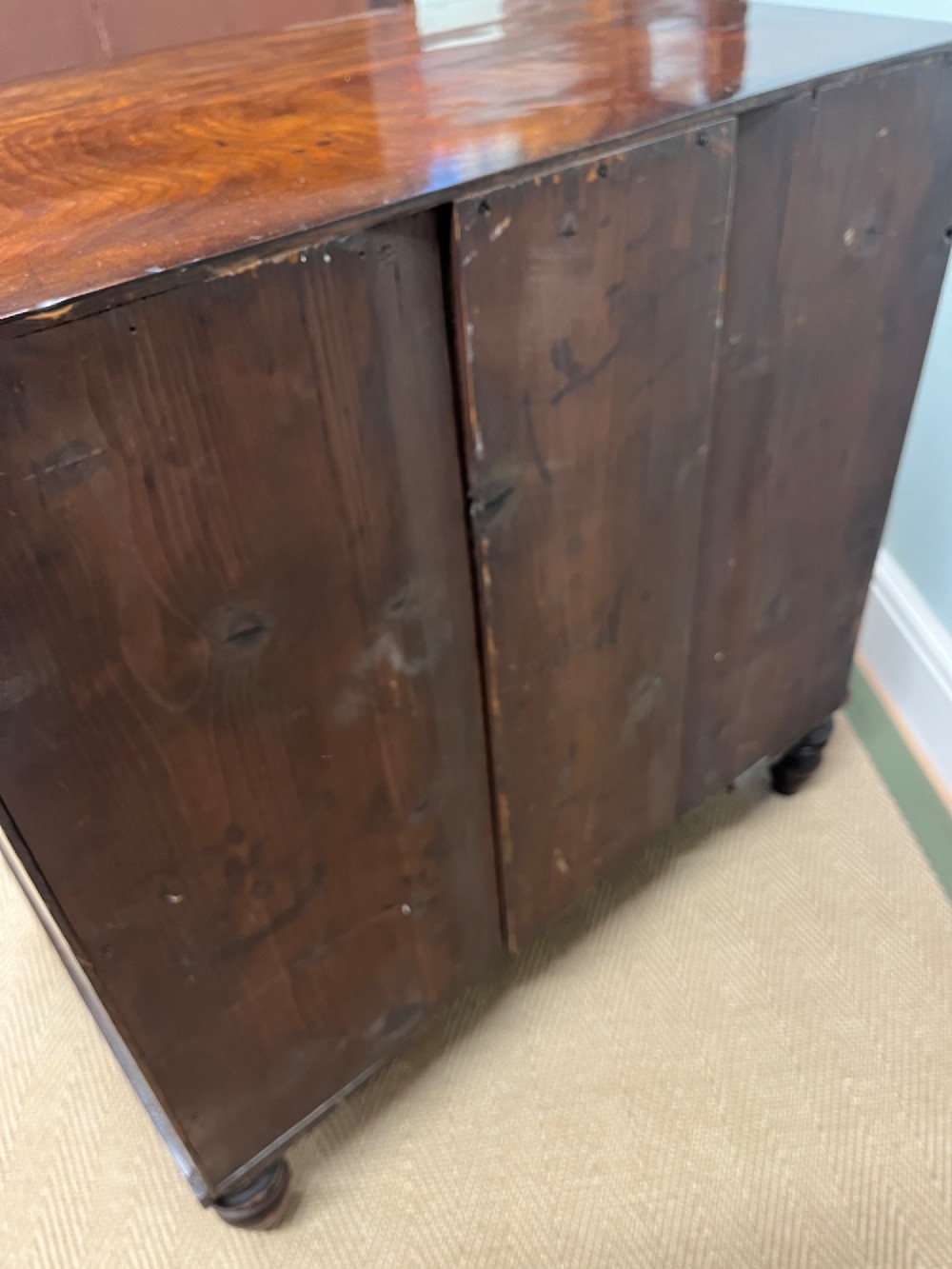 A 19th-century mahogany bowfront chest of drawers featuring three graduated drawers with turned wooden handles. View VIII