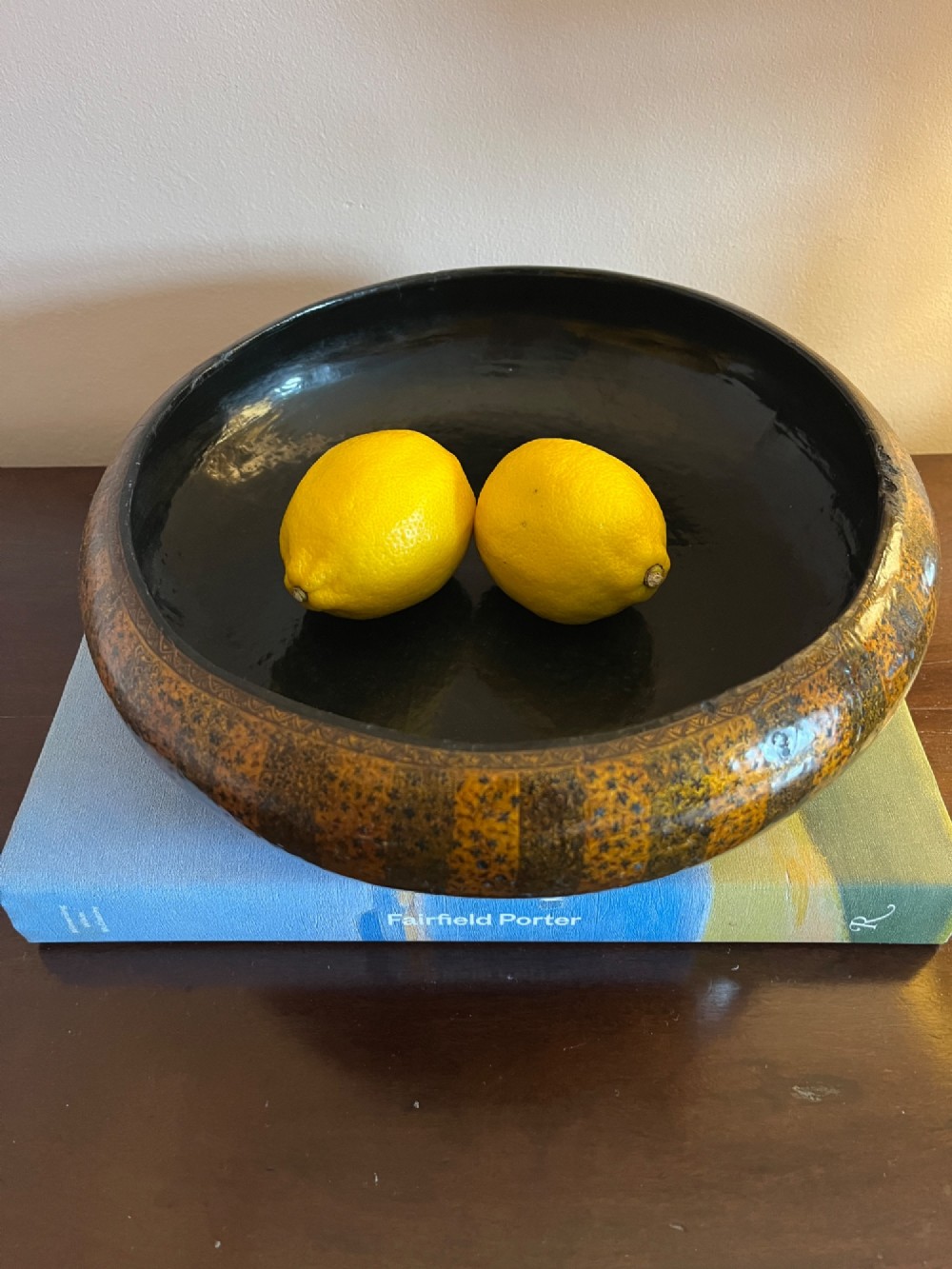 A shallow rounded 19th-century Kashmiri bowl decorated with vertical gold and black floral lacquer patterns and a dark lacquered interior. View III
