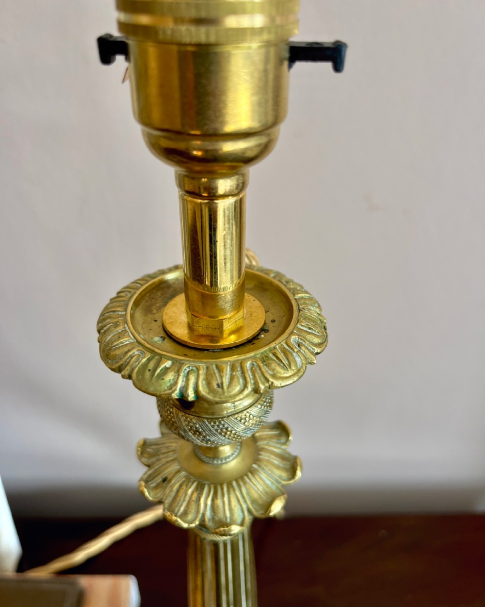 A pair of 19th-century fluted brass table lamps featuring claw feet bases and colourful pleated ikat fabric shades. View V