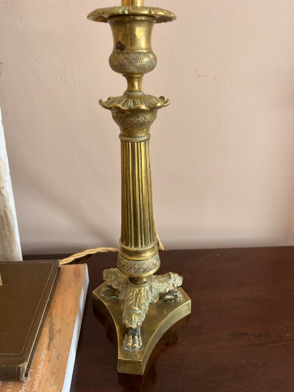 A pair of 19th-century fluted brass table lamps featuring claw feet bases and colourful pleated ikat fabric shades. View VI