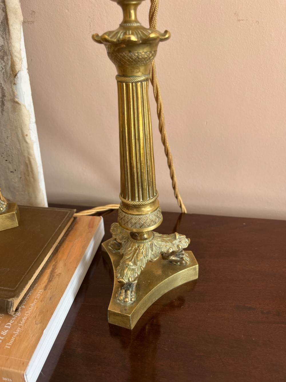 A pair of 19th-century fluted brass table lamps featuring claw feet bases and colourful pleated ikat fabric shades. View VII
