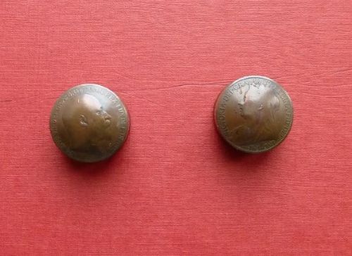 Three small circular antique brass snuff boxes with lids featuring raised profile portraits of British monarchs. View IV