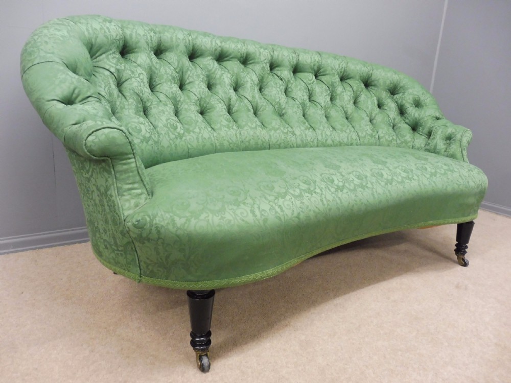 CHARMING CURVED VICTORIAN SOFA ON EBONISED LEGS CIRCA 1890 