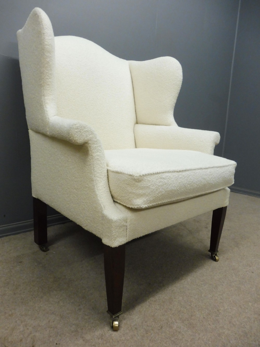 GENEROUSLY SIZED ANTIQUE WINGED ARMCHAIR CIRCA 1900