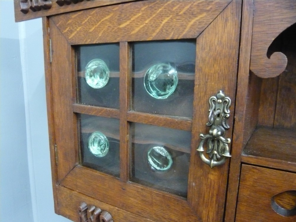ARTS AND CRAFTS CARVED OAK GLAZED WALL CABINET 1910 View IV