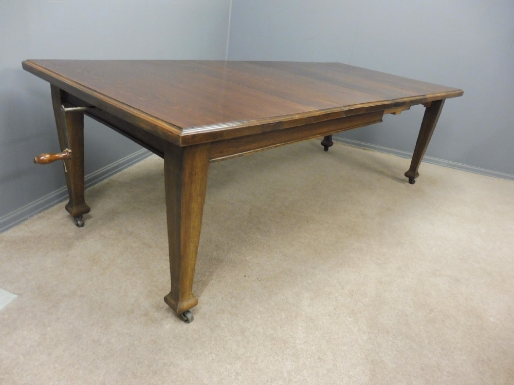 OAK ARTS AND CRAFTS EXTENDING DINING TABLE SEATS 10