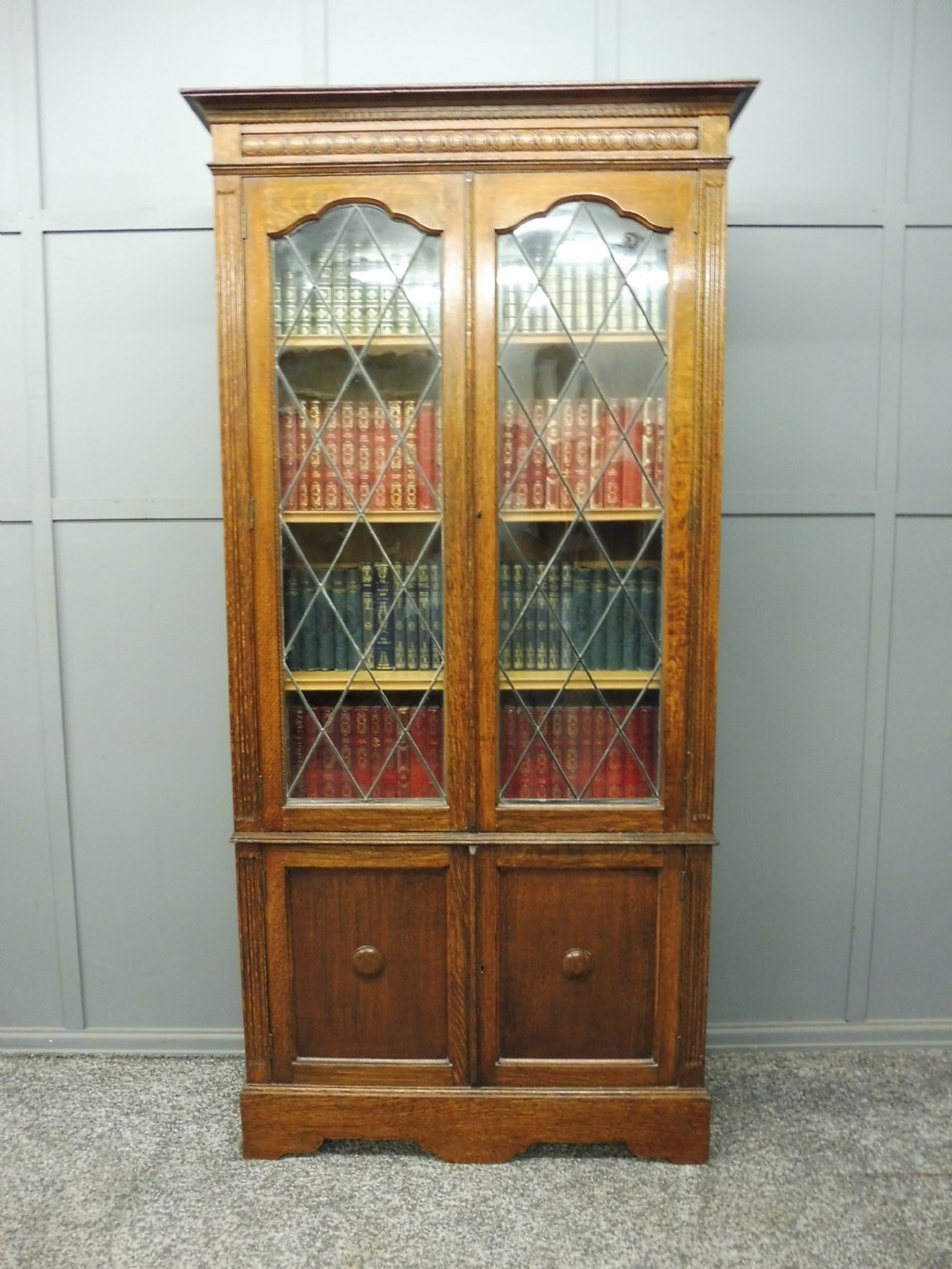 OAK BOOKCASE WITH LEADED GLASS DOORS