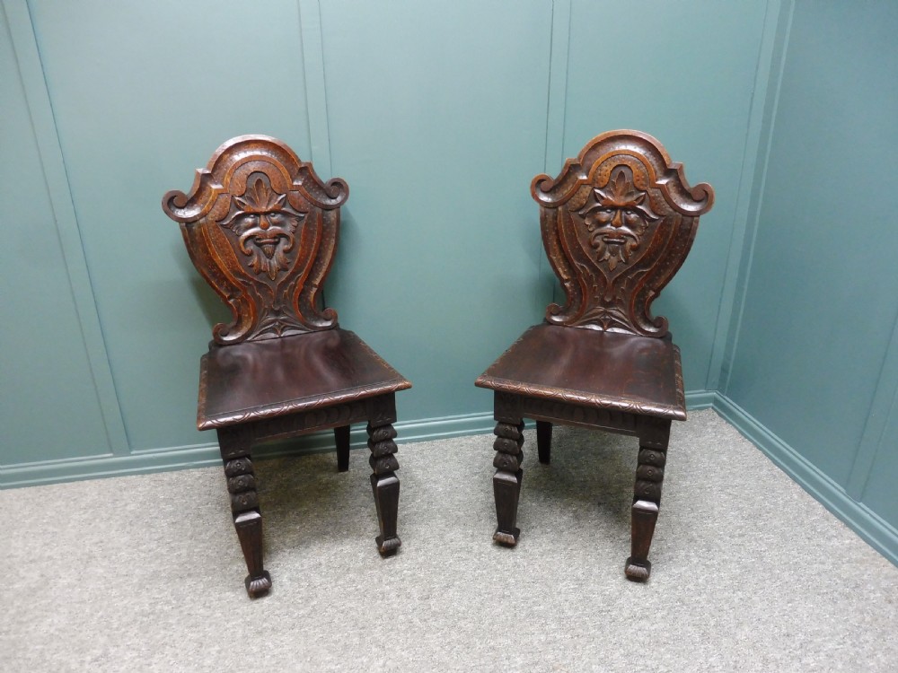 A PAIR OF 19TH CENTURY GREEN MAN HALL CHAIRS View II