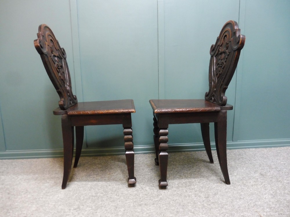 A PAIR OF 19TH CENTURY GREEN MAN HALL CHAIRS View VI