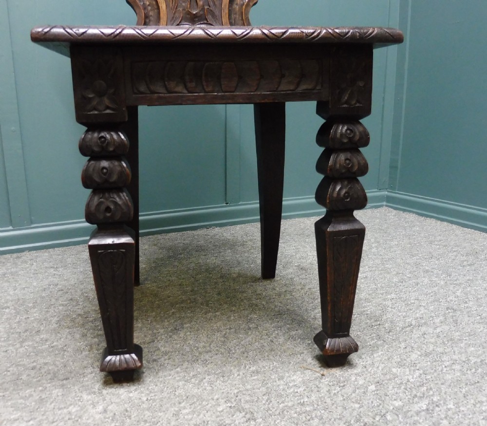 A PAIR OF 19TH CENTURY GREEN MAN HALL CHAIRS View X