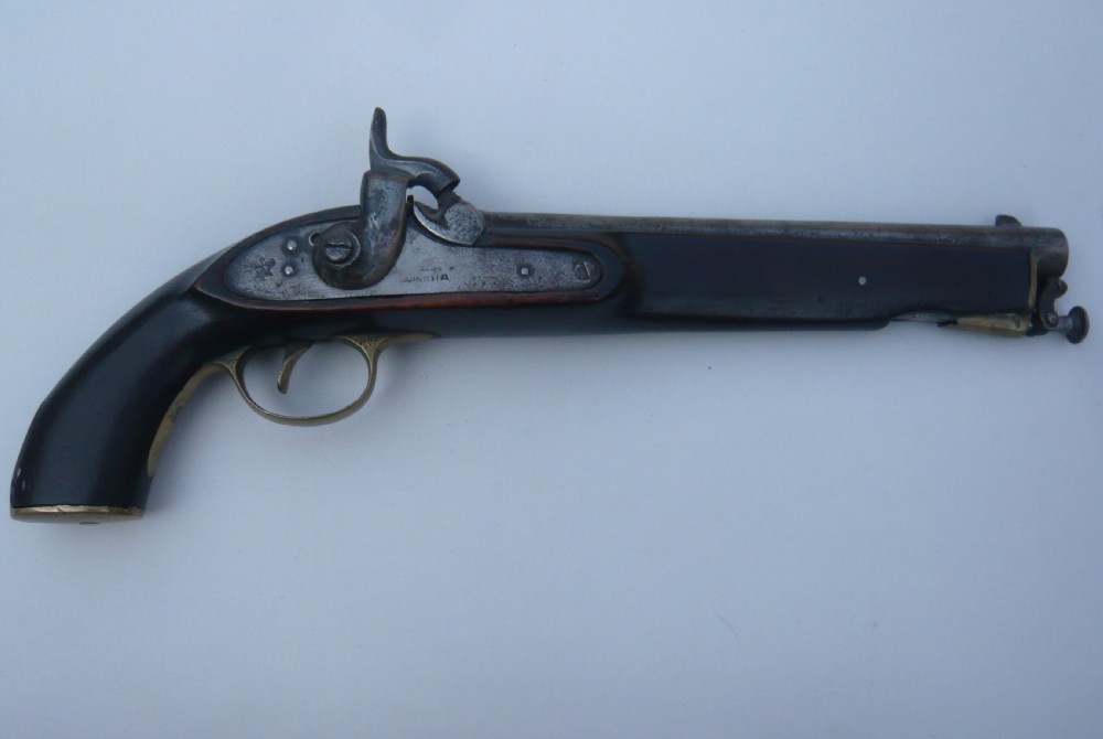 A 19th-century military percussion pistol featuring a dark hardwood stock, steel barrel, lockplate mechanism, brass trigger guard, and captive ramrod.