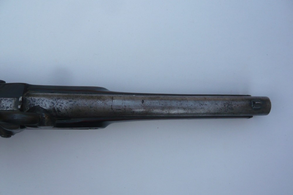 A 19th-century military percussion pistol featuring a dark hardwood stock, steel barrel, lockplate mechanism, brass trigger guard, and captive ramrod. View VI