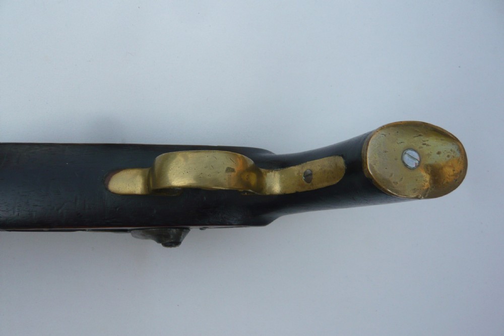 A 19th-century military percussion pistol featuring a dark hardwood stock, steel barrel, lockplate mechanism, brass trigger guard, and captive ramrod. View VIII