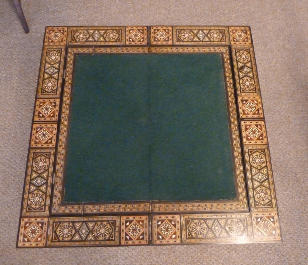 A Syrian Damascus card table featuring geometric wood and bone inlay work supported by curved cabriole legs. View V