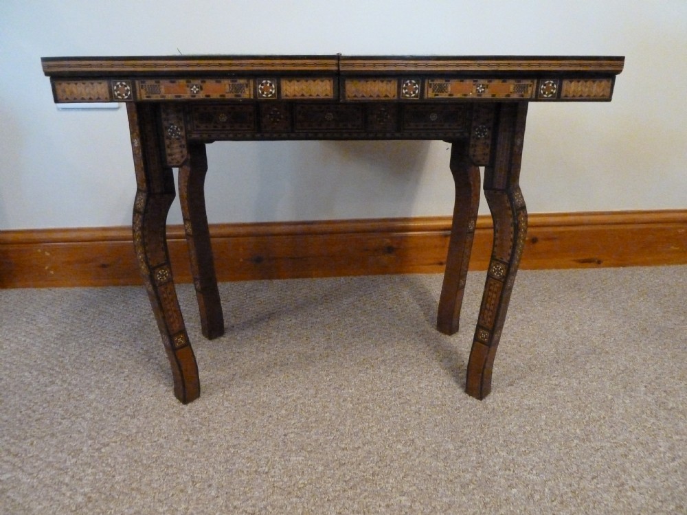 A Syrian Damascus card table featuring geometric wood and bone inlay work supported by curved cabriole legs. View VI