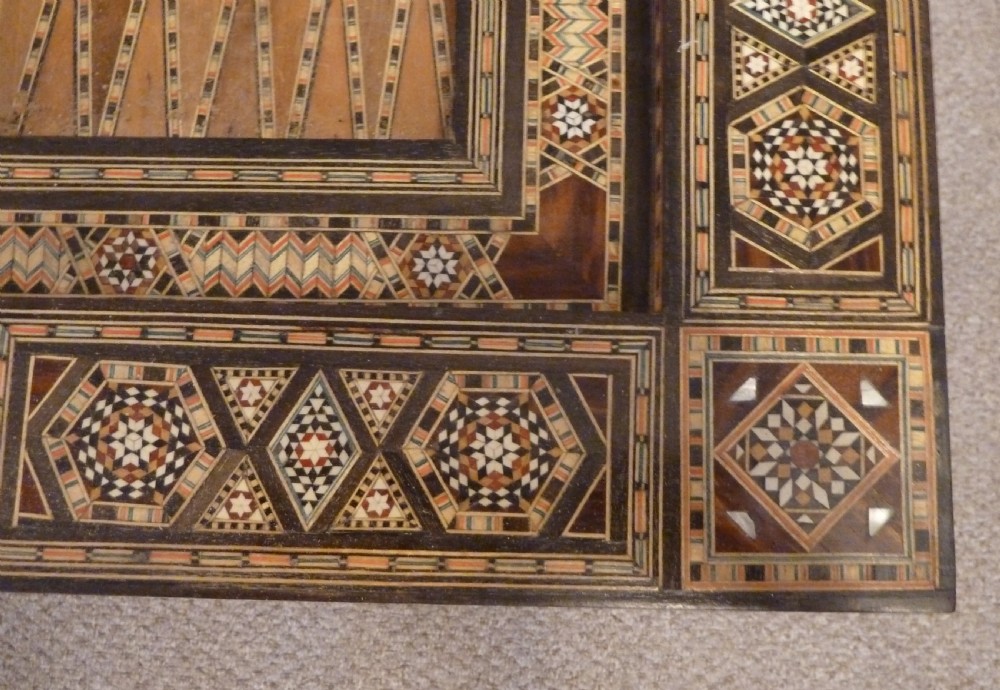 A Syrian Damascus card table featuring geometric wood and bone inlay work supported by curved cabriole legs. View X